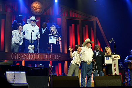 From left, Pam Matthews, executive director of the International Entertainment Buyers Association, Charlie Daniels, MTSU President Sidney A. McPhee, and MTSU Recording Industry major Jordan Todd at a 2013 appearance at the Grand Ole Opry. McPhee surprised Daniels with a presentation that formally announced the Charlie Daniels Scholarship at the Murfreesboro university. (MTSU file photo by Andy Heidt)