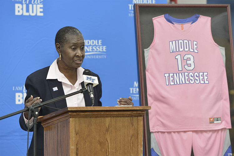 Dr. Gloria Bonner, MTSU special assistant to the president and a breast cancer survivor, speaks about the importance of cancer research and awareness during a press conference Monday, Feb. 3, inside the Kennon Sports Hall of Fame. At right is a special pink uniform like those that will be worn by the women's basketball team Saturday, Feb. 8, at the Play 4Kay Power of Pink game at Murphy Center. (MTSU photo by Andy Heidt)