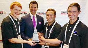 Three members of MTSU's EMC Productions student TV production team accept the top national collegiate honor Wednesday for “Outstanding Live Game and Event Production” at the 2014 College Sports Media Awards in Atlanta. From left are senior Chris Robertson of La Vergne, Tennessee, director of EMC Productions; ESPN's Rece Davis, who served as host for the awards event; senior Justin Beasley of Humboldt, Tennessee; and junior Joshua Cragg of Murfreesboro. (Photo courtesy of Mike Forbes)
