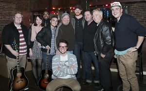 MTSU songwriters pose for a group photo after the Dec. 7 inaugural benefit concert for the Department of Recording Industry’s commercial songwriting concentration at Nashville's Listening Room Cafe. Standing from left are MTSU students Kyle Crownover, Caitlin Spencer, Terrez Sieber and Collin Baxter; program coordinator Odie Blackmon; MTSU alumnus Eric Paslay and his fellow and Grammy-nominated songwriter Dylan Altman; mass communication dean Ken Paulson; and MTSU student Nick Carpenter. MTSU student Zack Russell is kneeling in front. (Photo submitted)