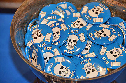 Buttons of support for the MTSU Debate Team were on display outside the State Farm Lecture Hall for an April 1 exhibition debate against a three-member team from Ireland. The debate was held at the Building and Aerospace Building.