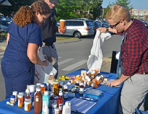 MTSU pharmacist Tabby Ragland tosses a liquid medication into a marked container Sept. 24 during the fifth MTSU Drug Take-Back Day outside the Student Health, Wellness and Recreation Center. MTSU officials collected unused and unwanted medicines from the campus community and general public.