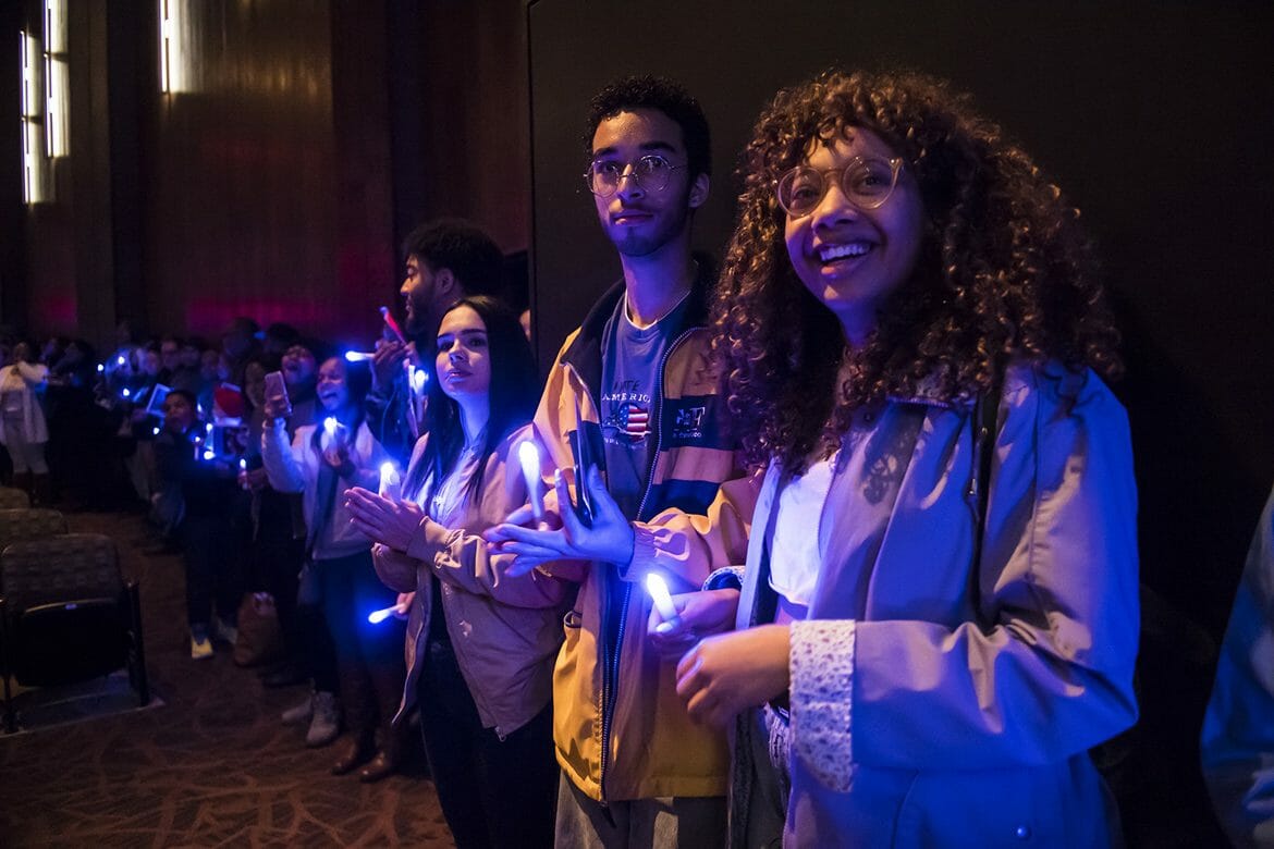 Holding blue-lit electronic candles, MTSU students join together in a closing song during the Monday, Jan. 15, celebration and candlelight vigil at Tucker Theatre in honor of Dr. Martin Luther King Jr. (MTSU photo by Eric Sutton)