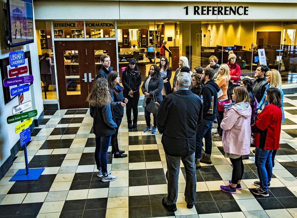 Visitors learn about James E. Walker Library during a campus tour.