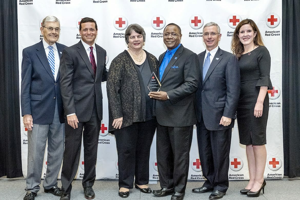 Middle Tennessee State University President Sidney A. McPhee, third from right, holds the 2018 Hero Award during the American Red Cross Heroes Breakfast held Feb. 21 inside the MTSU Student Union Ballroom. Pictured, from left, are John Hood, MTSU director of community engagement and support; MTSU alumnus and multimedia professional and former TV anchor Nick Paranjape; Linda Gilbert, director of Murfreesboro City Schools; McPhee; Gordon Ferguson, president and CEO of Saint Thomas Rutherford Hospital; and Kathy Ferrell, executive director, American Red Cross Heart of Tennessee Chapter. (MTSU photo by J. Intintoli)