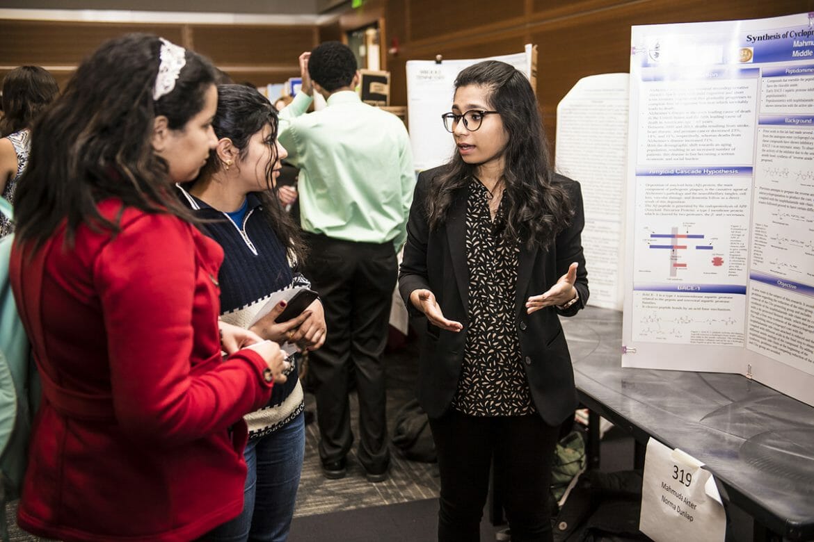 MTSU biochemistry major and May 2018 graduate Mahmuda Akter, right, explains her research to fellow students attending the Scholars Week universitywide Scholars Day event in the Student Union Ballroom in March 2018. Scholars Week will be held March 18-22, with the finale event set for Friday, March 22, in the Student Union Ballroom. (MTSU photo by Eric Sutton)