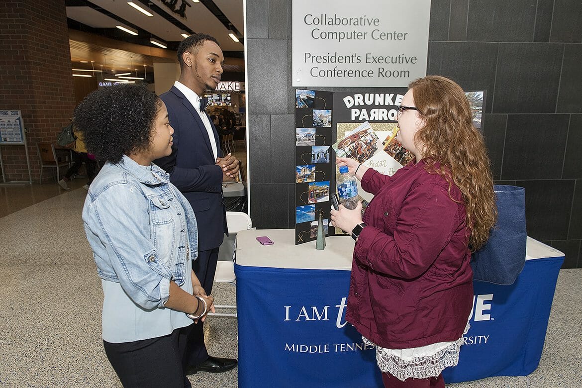 MTSU freshman Emili Knox, front left, and sophomore Hilary Huyler, back left, and senior Shannon Spehr chat March 28 about Huyler’s business plan during the Jones College of Business Student Trade Show preliminary competition held in the Student Union Atrium. (MTSU photo by Andy Heidt)