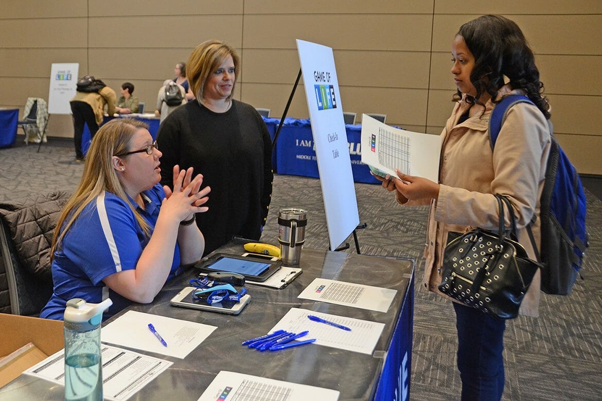 Shatayia Wilson, right, an MTSU sophomore social work major from Knoxville, Tenn., checks in to the “Game of Life” financial literacy challenge April 5 in the Student Union Ballroom. At left, seated, is Kristen Russell, coordinator of outreach and support programs in MT One Stop, and Jackie Victory, director of Student Organizations and Service. (MTSU photo by Jayla Jackson)