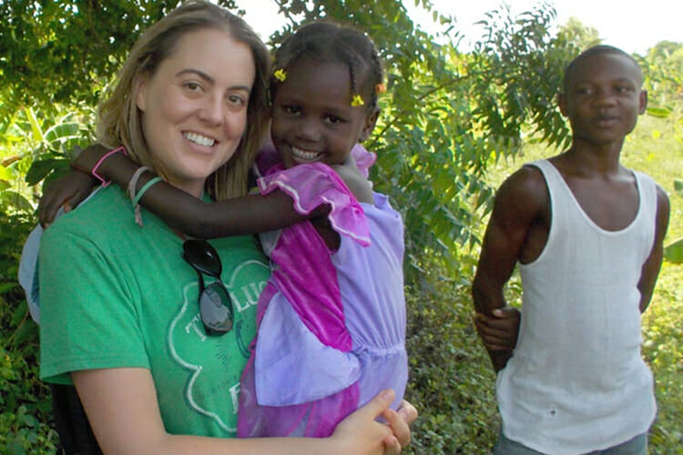 MTSU alumna Monique Richard cuddles a young friend as another pal looks on during a 2014 mission trip to Haiti with the Aziz Foundation to teach nutrition to residents there. Richard, who was recognized in the March 2018 edition of Today’s Dietitian magazine as one of 10 U.S. “Dietitians Who Are Making a Difference,” was the first dietitian to join doctors and nurses in relief missions to Haiti with the nonprofit Azil Foundation. (Photo courtesy of Monique Richard)