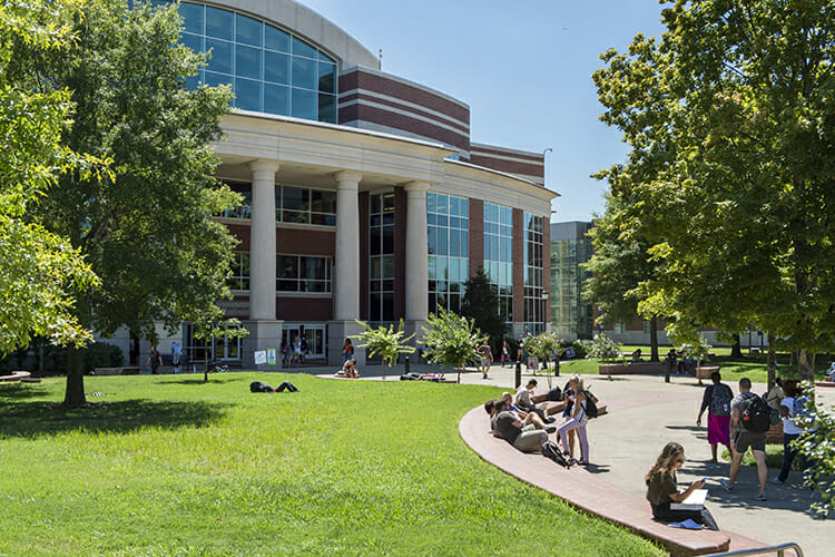 MTSU students gather to visit, study and relax along the quad outside the James E. Walker Library on a late June afternoon with the new Science Building in the background. The university will test its Critical Notification System today, June 27, with a simple email, text and voice message to more than 25,000 users to ensure that students, faculty and staff properly receive urgent communications. (MTSU file photo by Andy Heidt)