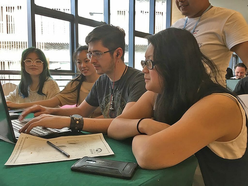 MTSU animation student Ryan Barry, at center on laptop, takes the lead on editing a 30-second film collaboration with classmate Chi Nguyen, right, and their international team members as part of their participation in the second annual Wonderful World: 2018 International Students Ocean Short Film Exhibition held in Guiyang, China. (Submitted photo)