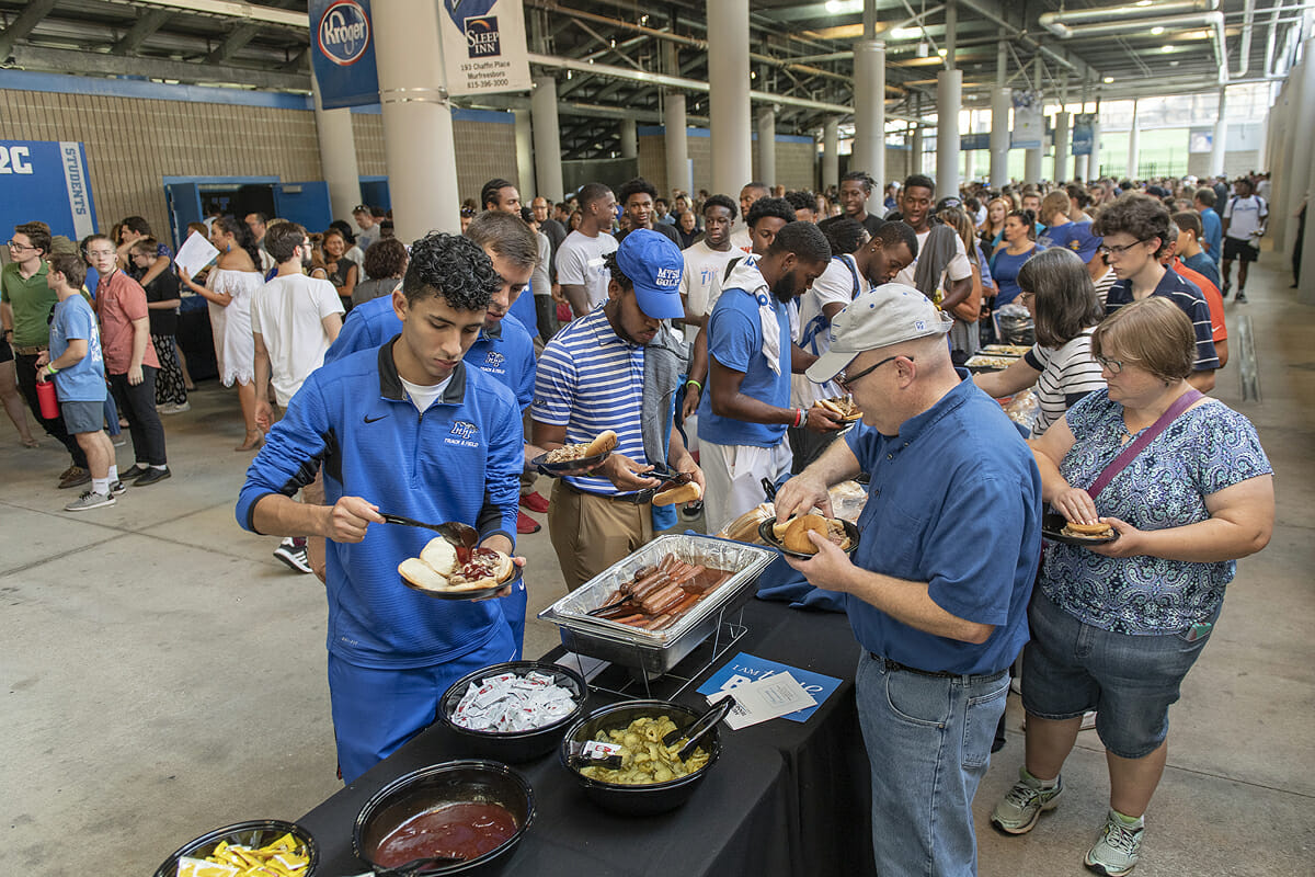 Attendees at the fall University Convocation go through the line to select barbecue, hot dogs and more during the annual President’s Picnic in August 2018 underneath Floyd Stadium. The President’s Picnic follows Convocation on Saturday, Aug. 24. (MTSU file photo by Andy Heidt)