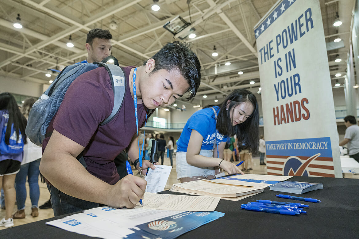 Incoming MTSU students Skyler Senesombath and Amy Lin register to vote as Zachary Brow awaits his turn at one of the True Blue Voter registration tables available this summer at the Campus Recreation Center during the CUSTOMS new student orientation sessions. Almost 200 students were registered during the ongoing initiative in partnership with the Rutherford County Election Commission. (MTSU file photo by J. Intintoli)