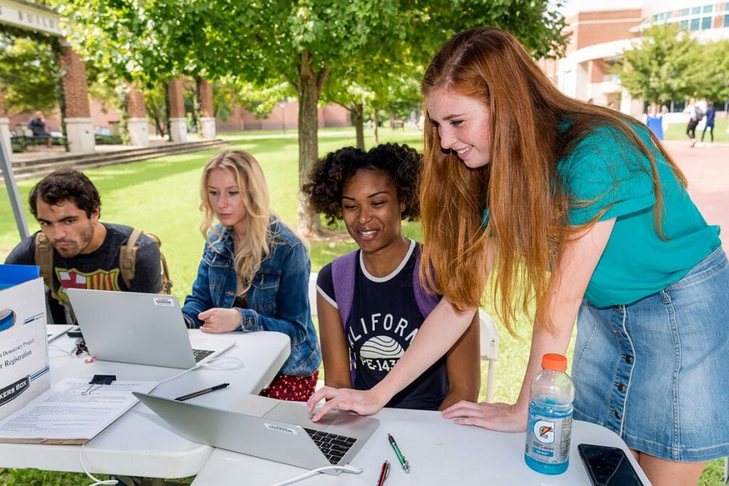 From left, Sam DeLoach, Christy Fell and KeWana McCallum register to vote assisted by volunteer Shelby Ziegler of Alpha Chi Omega sorority outside the University Honors Building Oct. 9. (MTSU photo by J. Intintoli)