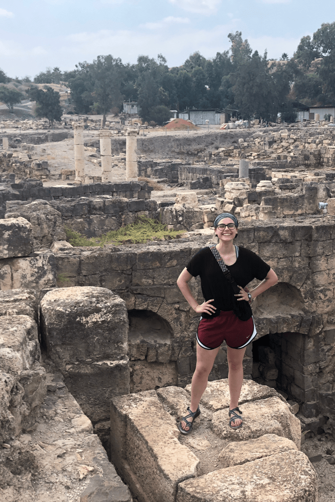Hannah Solima stands in front of ancient ruins while abroad.