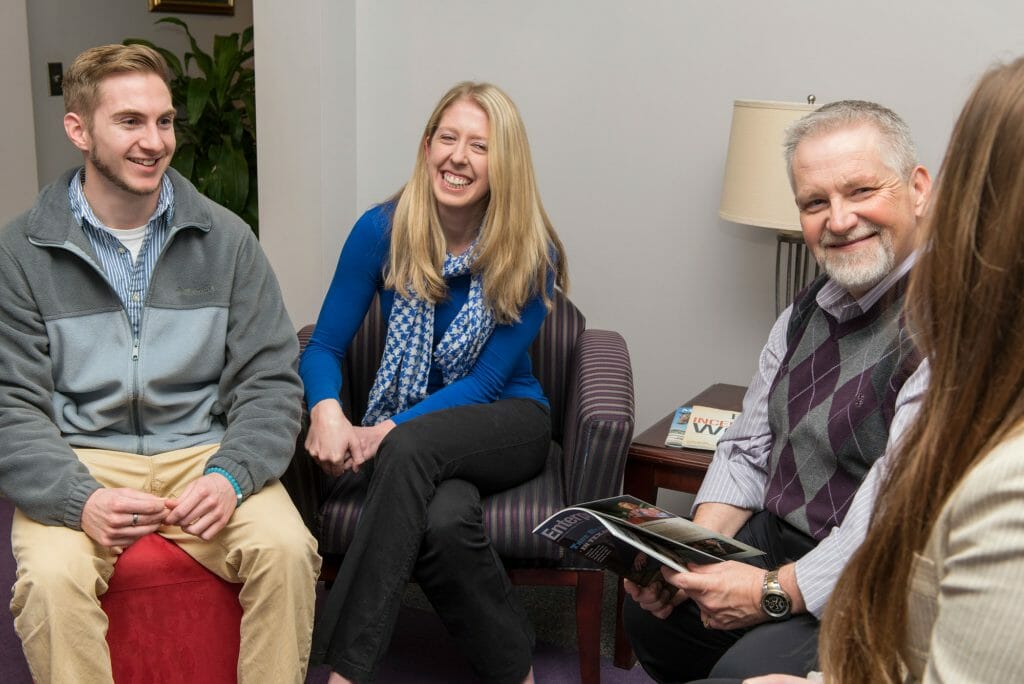 Master of Business Education professor, Vince Smith, sitting and talking with his graduate assistants (l to r): Nick Wise, Amanda Goodman, Professor Vince Smith, Stephanie Keys. Photo by Kimi Conro.