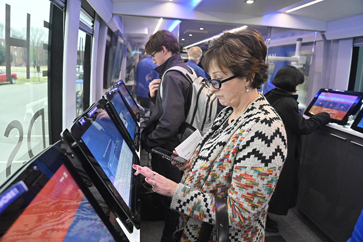 Terri Donovan, who teaches media writing at MTSU, takes an interactive quiz aboard the C-SPAN Bus, which stopped at MTSU Jan. 16. (MTSU photo by J. Intintoli)