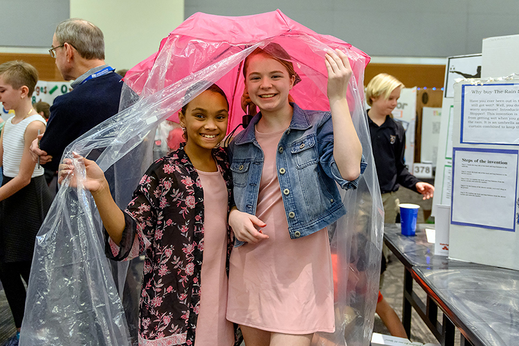 Murfreesboro sixth-graders Brianna Guthrie, left, and Abby Gibbs of Northfield Elementary School have the solution to "Make Life Easier" after Middle Tennessee's weeks of soggy weather: "The Rain Stopper," their creation for MTSU's 27th annual Invention Convention, held Feb. 21 in the university's Student Union Ballroom. The duo was among nearly 800 Midstate youngsters attending this year's event, displaying a total of 375 inventions. (MTSU photo by J. Intintoli)