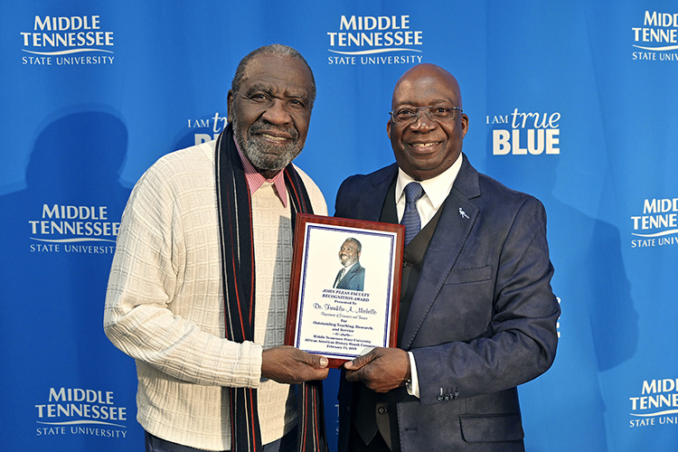 John Pleas, MTSU Emeritus Professor of Psychology, left, presents Frank Michello, MTSU finance professor, with the 2019 John Pleas Faculty Recognition Award at a ceremony held Thursday, Feb. 21, in the Ingram Center at MTSU. The award is presented to an outstanding minority faculty member. (MTSU photo by Andy Heidt)