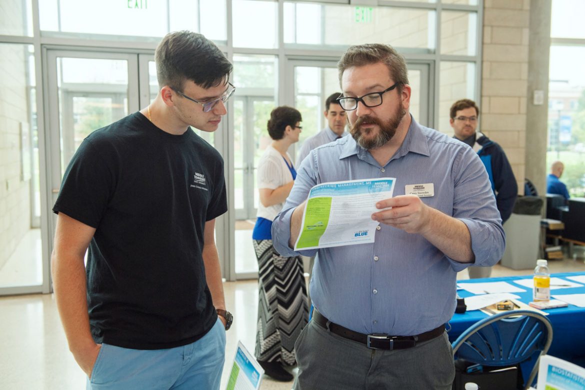 Chemistry Career Fair in the Science Building Atrium. Liija Zecevic, 21, left, an MTSU senior biochemistry major from Nashville, learns about the university’s Master of Science in Professional Science Program from Carey Snowden. Photo: Andy Heidt