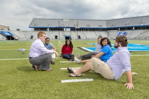 Dr. Joey Gray, far left, talks with students on the field at MTSU's Floyd Stadium during the spring 2015 semester. Gray is an associate professor in MTSU's Sports, Leisure and Tourism Studies Program. Students shown include, from bottom right, Connor Fite, Tara Fleming, JT Farmer, Takyra Wright and Requavius Macon. (MTSU photo by J. Intintoli)