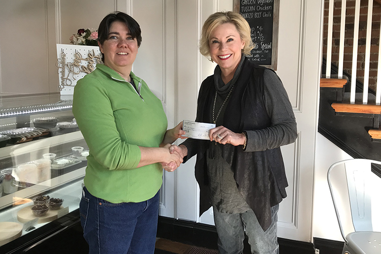 Michelle Willard, left, vice president of Locally Owned Murfreesboro, presents a scholarship check to Carolyn Tumbleson, development director for MTSU’s Jones College of Business. The funds were raised a the Downtown on the Farm event last fall. (Photo courtesy of Locally Owned Murfreesboro)