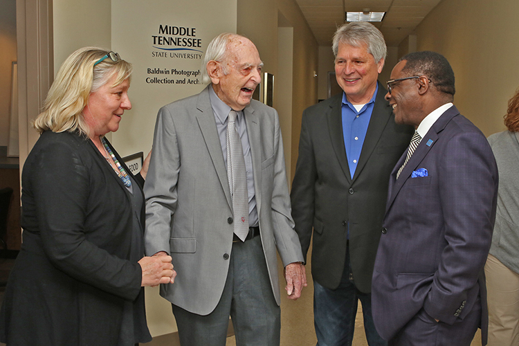 From left, Baldwin Photographic Gallery curate Jackie Heigle, Professor Emeritus Harold Baldwin, Department of Media Arts Chair Billy Pittard and MTSU President Sidney A. McPhee share a light-hearted Monday following the March 20 ribbon-cutting of the new Baldwin Photographic Collection and Archive on the second floor of the Miller Education Center on Bell Street. (MTSU photo by James Cessna)