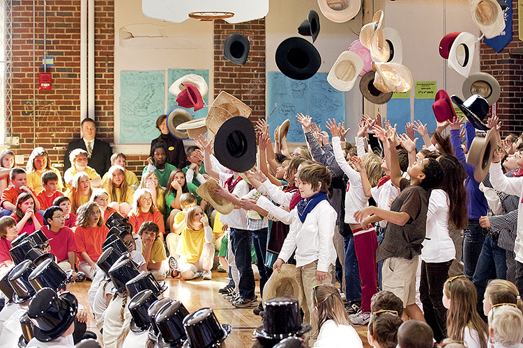 Third-grade students at Homer Pittard Campus School toss their hats in the air while performing "I'm an Old Cowhand" in the gymnasium at the school’s 80th anniversary celebration in this 2009 file photo. Campus School is celebrating 2019 as its 90th year of service to elementary school students — and to Middle Tennessee State University education majors who did their student teaching there — with a big April 16 event. (MTSU file photo by J. Intintoli)