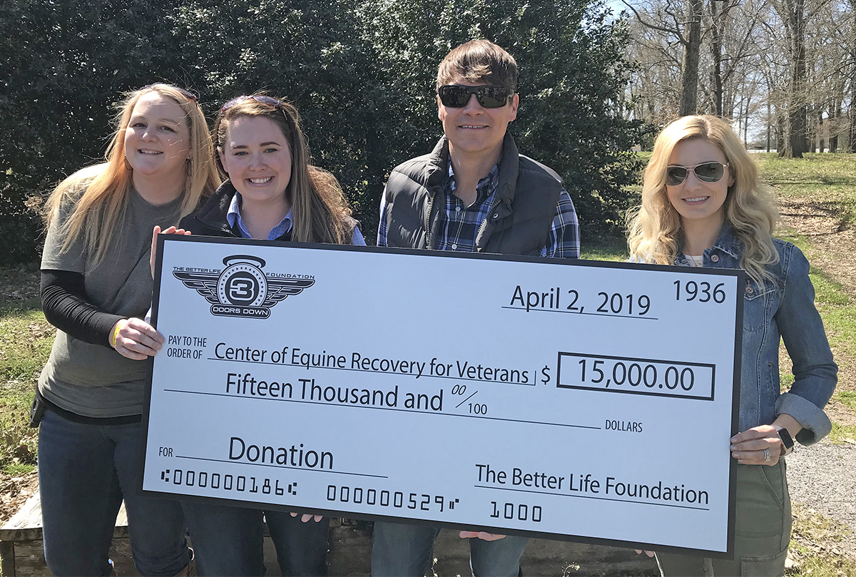 Sarah Howard, left, recreation therapist for the VA’s Veterans Recovery Center in Murfreesboro, and MTSU horse science faculty member Andrea Rego accept a $15,000 check from Brad and Jen Arnold and the rock band 3 Doors Down’s Better Life Foundation to benefit the Center of Equine Recovery for Veterans, or CERV, recently at the Horse Science Center on West Thompson Lane. 