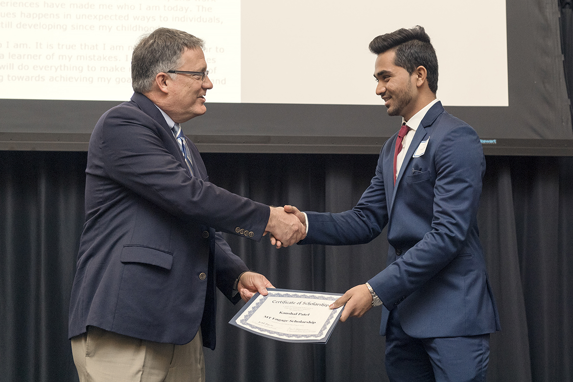 University Provost Mark Byrnes, left, congratulates Jones College of Business student Kaushal Patel for winning a scholarship during the 2019 Spring MT Engage Reception held April 4 in the Student Union Ballroom. (MTSU photo by Andy Heidt)