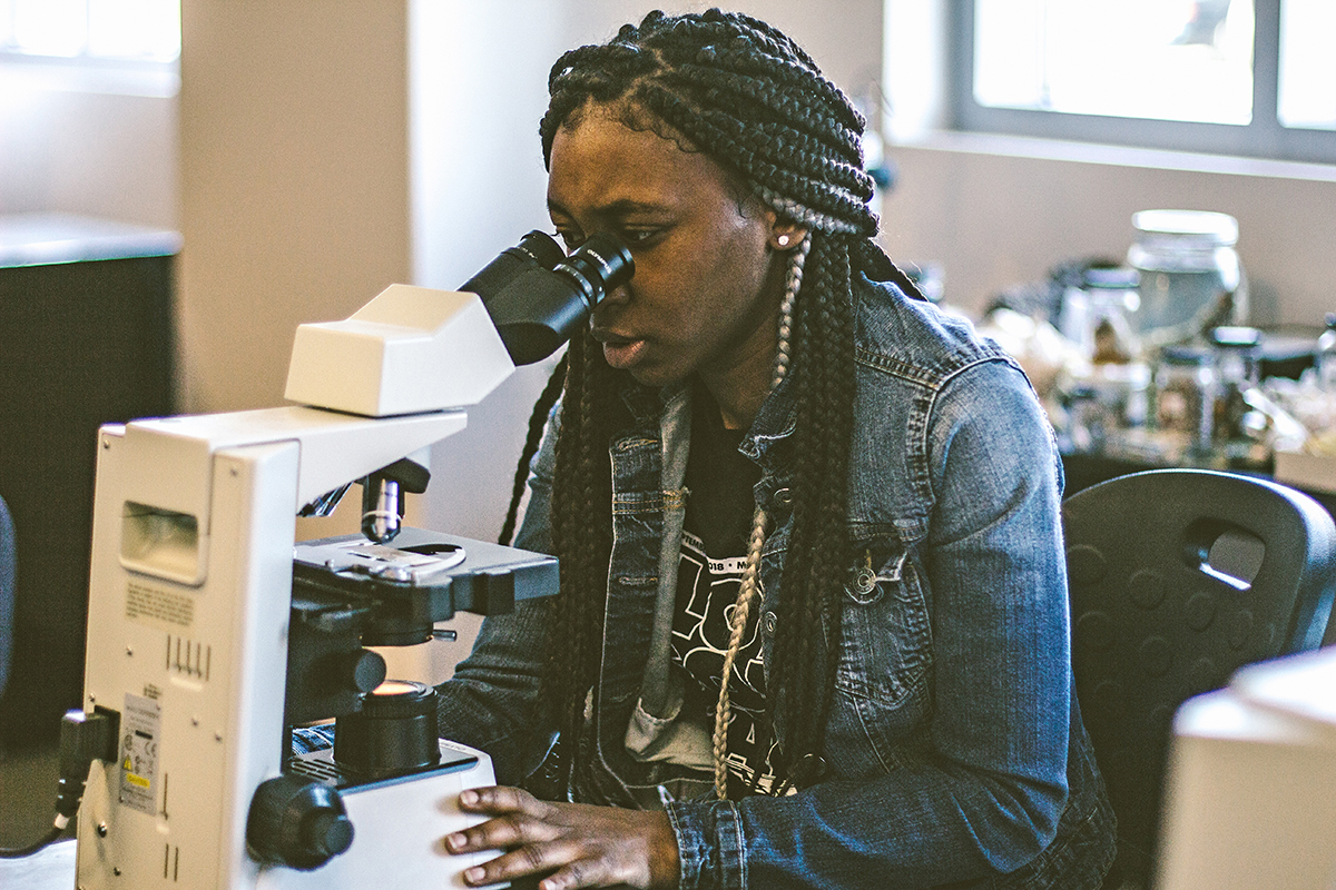 Angela Maxwell, 21, an MTSU junior biology major from Memphis, Tenn., studies marine life through a microscope in a Science Building teaching lab. She said she “discovers something new almost every week.” 