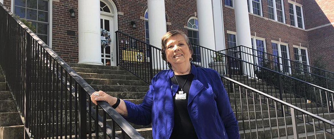 Dr. Rita King, former principal and current president of the school’s support group, Friends of Campus School, stands in front the school on East Lytle Street. (Photo courtesy of James Evans, Rutherford County Schools)
