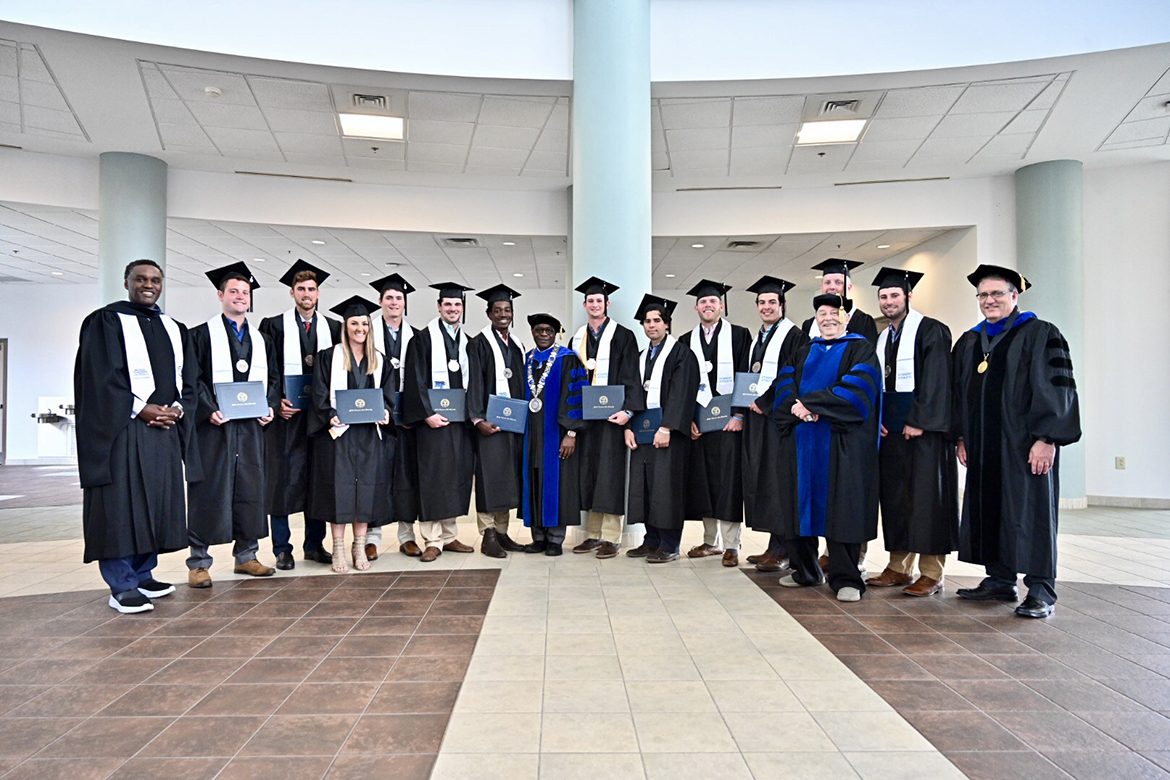 MTSU President Sidney A. McPhee, center, is shown with other university officials and graduating student athletes Tuesday, April 23, at a special commencement ceremony held for those Blue Raider student athletes who have upcoming competition commitments and will be unable to attend the regular May 4 commencement at Murphy Center. The special ceremony was held in the second floor atrium of the Miller Education Center on Bell Street. (MTSU photo by J. Intintoli)