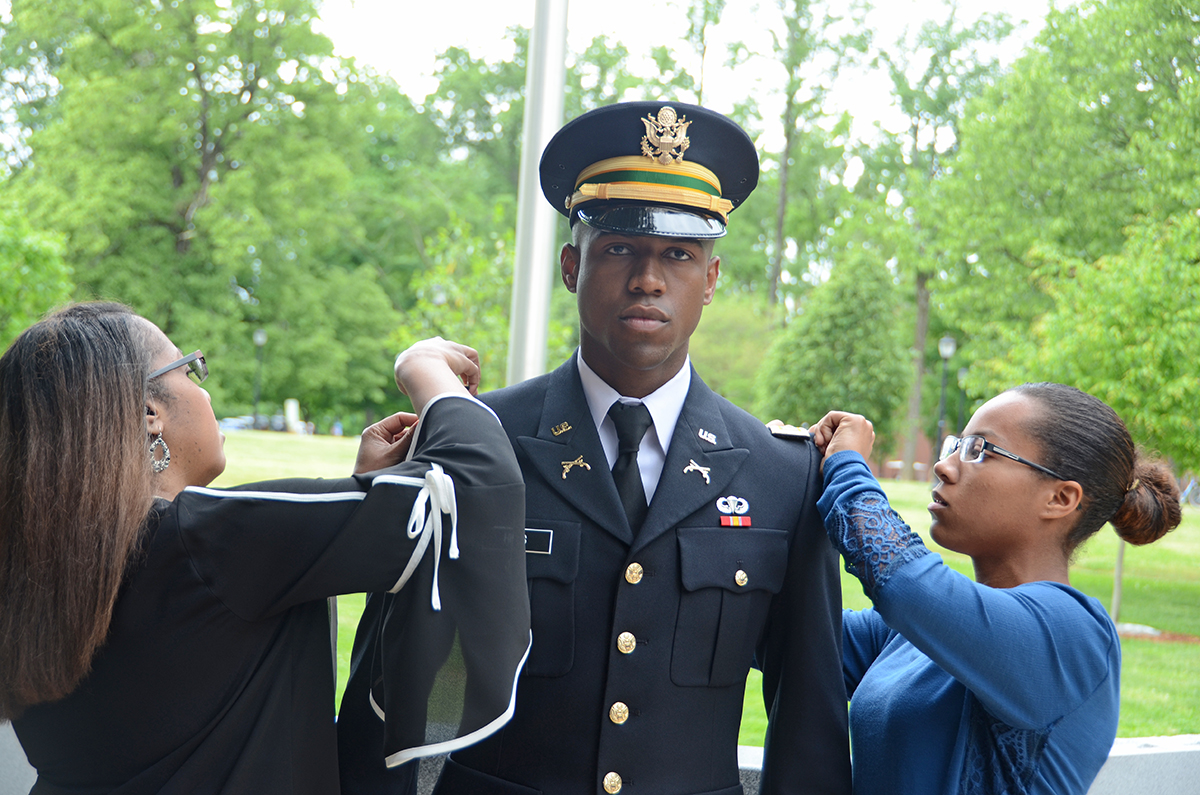 MTSU senior Antonio Hiles Jr., center, of Shelbyville, Tenn., is pinned by his mother, Sylvia Hiles, left, and sister Keauna Hiles Friday, May 3, during the spring commissioning ceremony at the Veterans Memorial outside the Tom H. Jackson Building. The criminal justice major will start his career in the Army National Guard’s military police branch. 