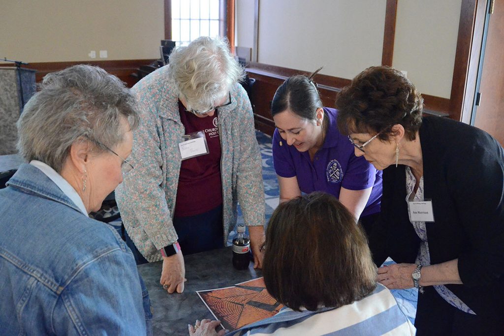Tiffany Saul, at right in purple shirt, a research assistant professor with the MTSU Forensic Institute for Research and Education, or FIRE, assists students in this year’s Lifelong Learning Program with a fingerprint puzzle during Saul’s May 13 session, “How to Solve a Crime Part 2.” The annual program is hosted by the College of Liberal Arts at the Ingram Building’s MT Center. (MTSU photo by Jimmy Hart)