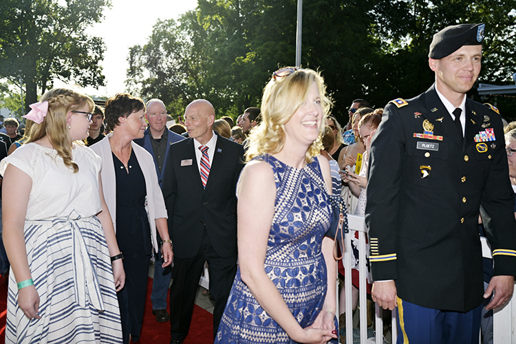 Alexis Huber, left, daughter of retired Army Lt. Gen. Keith Huber, MTSU’s senior adviser for veterans and leadership initiatives, joins her mother, Shelly, to her right, and her father, center, in walking the red carpet before the Grand Ole Opry’s Salute The Troops show Tuesday in Nashville, Tenn. (MTSU photo by Andy Heidt)
