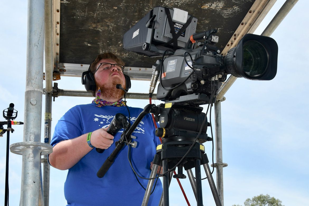 Taylor Sullivan, a music business and video production major at MTSU, gets up close to the action Sunday, June 16, while filming a concert on the Bonnaroo Who Stage in Manchester, Tenn. (MTSU photo by Andrew Oppmann)