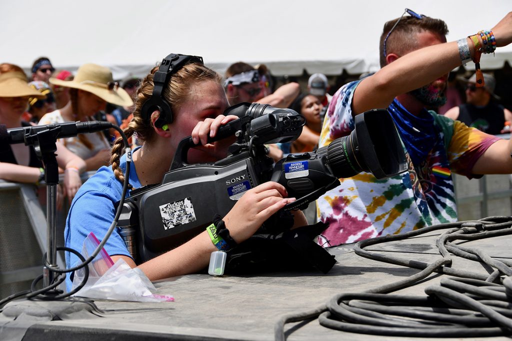 Taylor Sullivan, a music business and video production major at MTSU, gets up close to the action Sunday, June 16, while filming a concert on the Bonnaroo Who Stage in Manchester, Tenn. (MTSU photo by Andrew Oppmann)