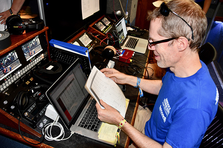 Michael Fleming, a professor in MTSU’s Department of Recording Industry, double-checks details Sunday, June 16, while mentoring students working on Bonnaroo’s Who Stage in Manchester, Tenn. (MTSU photo by Andrew Oppmann)