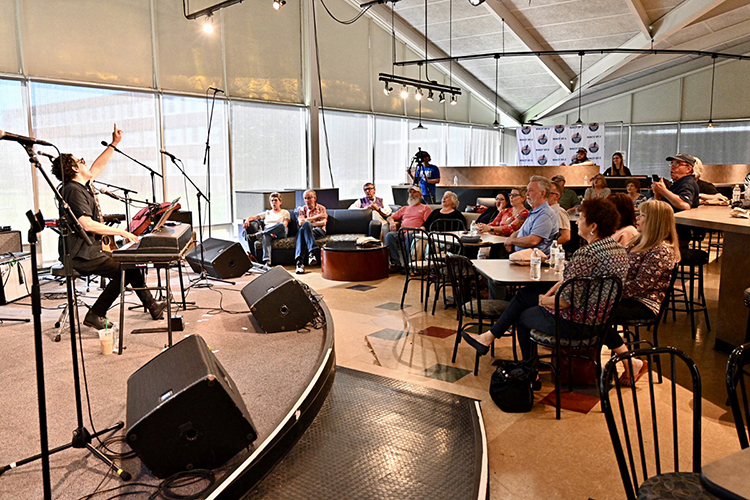 Singer-songwriter A.J. Croce, left, gestures during his set at the live 50th anniversary celebration for WMOT-FM Roots Radio 89.5 inside MTSU's Cyber Café in this April 2019 file photo as an attentive audience sings along and students work as videographers and sound engineers. The facility, which opened in 1963 as a dining hall sandwiched between south-side dormitories and now boasts the university's Science Building as a next-door neighbor, has been named for former MTSU student and Grammy-nominated country musician Chris Young and will be used as a combination eatery and live event space to help train students in the College of Media and Entertainment. (MTSU file photo by J. Intintoli)