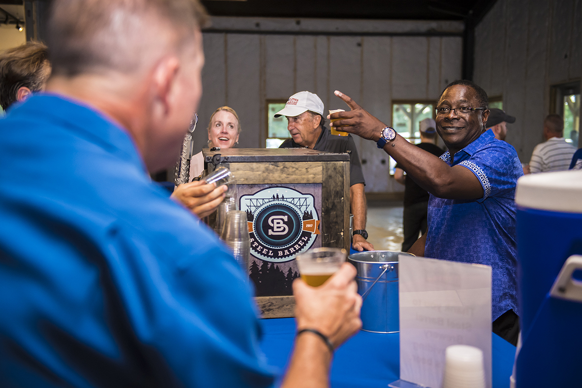 MTSU President Sidney A. McPhee, right, raises a toast during the 2018 Pigskin Pregame event last August at university fermentation science partner Hop Springs and Steel Barrel Brewery, once again a beverage sponsor for this year’s “Pigskin” event. It will be held at 6 p.m. Saturday, Aug. 10, at the home of Jonathan Harmon, 746 E. Main St., in Murfreesboro. (MTSU file photo by Eric Sutton)