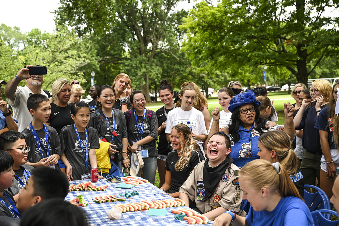 About 40 visiting Chinese middle school students on Sunday were treated to an all-American picnic — and welcomed by cheerleaders and scouts — at the home of Middle Tennessee State University President Sidney A. McPhee. (MTSU Photo by Kimi Conro)