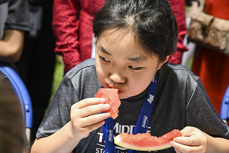 About 40 visiting Chinese middle school students on Sunday were treated to an all-American picnic — and welcomed by cheerleaders and scouts — at the home of Middle Tennessee State University President Sidney A. McPhee. (MTSU Photo by Kimi Conro)