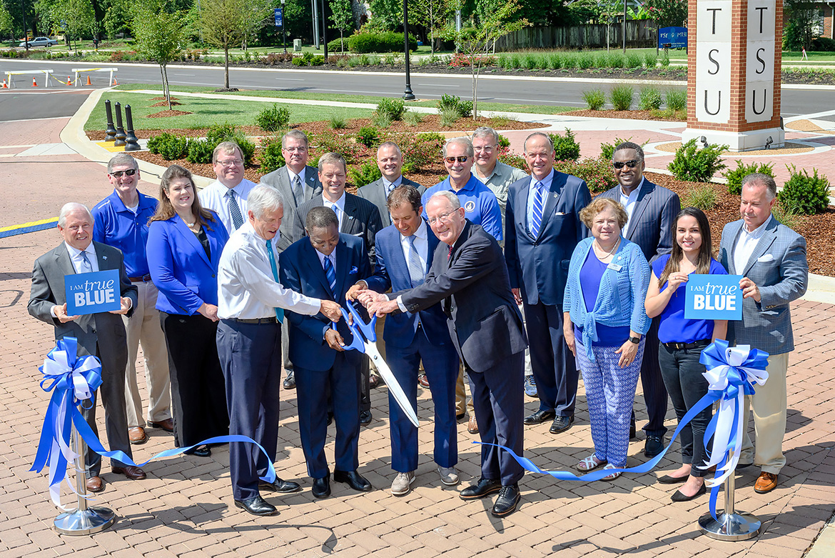MTSU and the city of Murfreesboro hosted a ribbon-cutting Friday, Aug. 2, to celebrate the completion of an $18.2 million renovation project to Middle Tennessee Boulevard. Cutting the ribbon, from left holding scissors, are former Congressman Bart Gordon, MTSU President Sidney A. McPhee, Murfreesboro Mayor Shane McFarland and U.S. Sen. Lamar Alexander. Pictured with them are a host of state, local and university representatives. (MTSU photo by J. Intintoli)