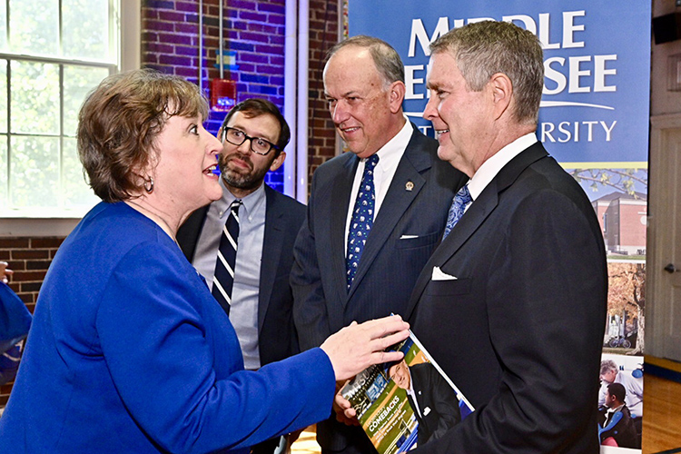 MTSU College of Education Dean Lana Seivers, left, chats with former Senate Majority Leader Bill Frist, founder and chairman of SCORE (State Collaborative on Reforming Education), at a signing ceremony held Wednesday, Aug. 28, at Homer Pittard Campus School, a K-5 teaching laboratory school owned by MTSU and operated by Rutherford County Schools. Looking on are SCORE President and CEO David Mansouri, center left, and MTSU Board of Trustees Chairman Stephen Smith. Middle Tennessee State University and SCORE signed an agreement that seeks to improve teacher training within the university’s College of Education. (MTSU photo by J. Intintoli)
