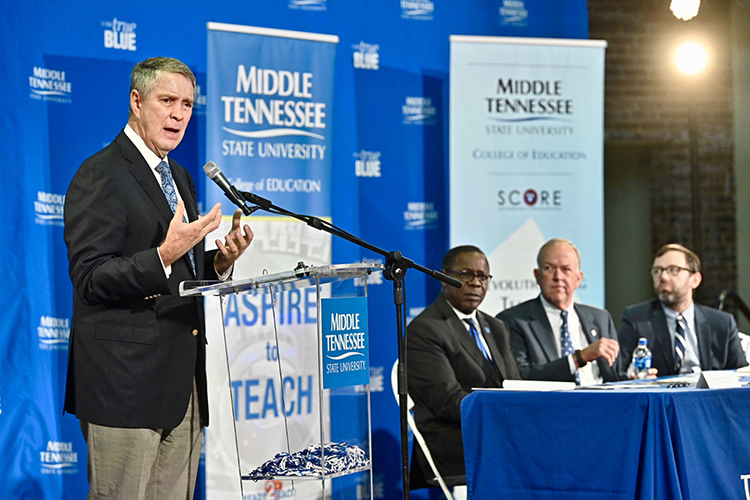 Former U.S. Senate Majority Leader Bill Frist, SCORE founder and chairman, talks about the agreement signed Wednesday, Aug. 28, between Middle Tennessee State University and SCORE (State Collaborative on Reforming Education) that seeks to improve teacher training within the university’s College of Education. Looking on, seated from left, are MTSU President Sidney A. McPhee, MTSU Board of Trustees Chairman Stephen Smith and SCORE President and CEO David Mansouri . The signing was held at Homer Pittard Campus School, a K-5 teaching laboratory school owned by MTSU and operated by Rutherford County Schools. (MTSU photo by J. Intintoli)