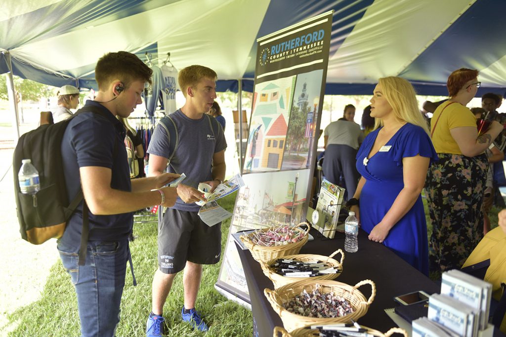 Abbie Wheeler, right, director of marketing and communications with the Rutherford County Chamber of Commerce, discusses the many offerings available to MTSU students, including Derek Green, left, of Knoxville, Tenn., and Payne Pignocco, 18, of Olive Branch, Miss., Tuesday, Aug. 27, during the annual Meet Murfreesboro in the Student Union Commons. Both are freshmen aerospace majors — Green in flight dispatch and Pignocco in professional pilot. (MTSU photo by James Cessna)