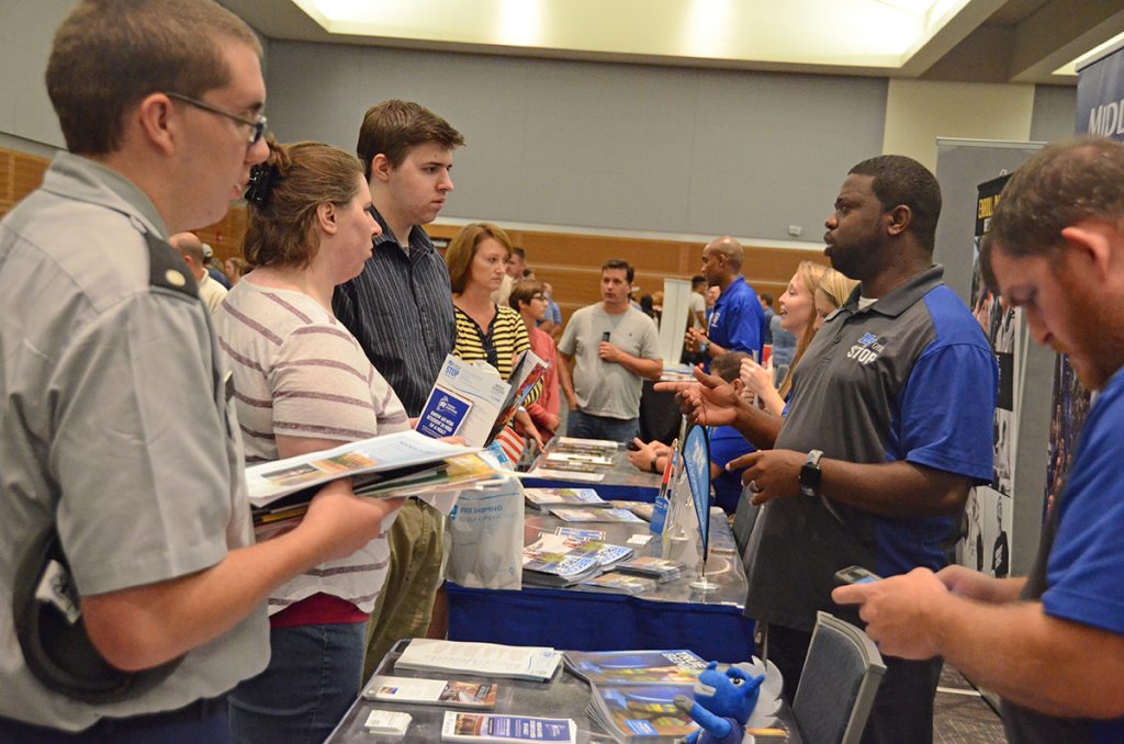 Along with James Taylor, right, from the MT One Stop, Chris Rochelle, second from right, who works in the Middle Tennessee State University Daniels Veterans Center, provide information and answer questions from prospective students and their parents attending a previous Rutherford County College Night. Guests will return for this year’s college night starting at 6 p.m. Wednesday, Sept. 6, in the Student Union Ballroom. (MTSU file photo by Randy Weiler)