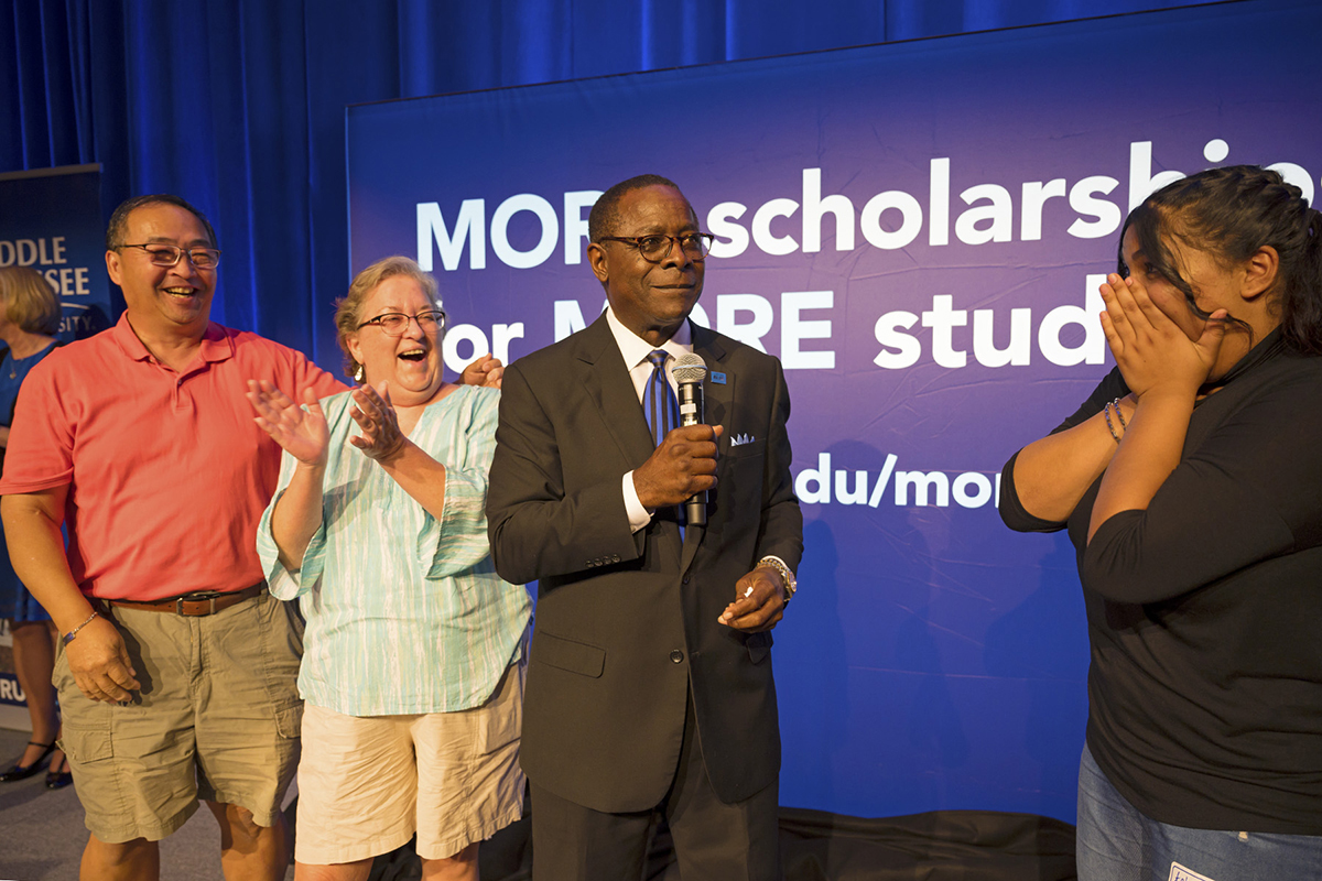 Prospective MTSU student Aelmira Esmaeilpour, right reacts with surprise after MTSU President Sidney A. McPhee awarded her a Blue Raider Scholarship recently during the kickoff event for the fall True Blue Tour in the Student Union Ballroom. McPhee unveiled a new True Blue Scholarship as an added incentive available in fall 2020 for students with a 3.5 GPA or higher and with an ACT score between 23 and 24. (MTSU photo by Cat Murphy)