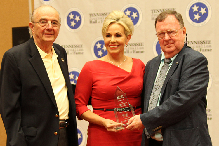 Valerie Calhoun, center, five-time Emmy Award winner and co-host of Good Morning Memphis on WHBQ-TV Fox 13, receives her award and certificate during the induction ceremony for the 2019 class of the Tennessee Journalism Hall of Fame held Tuesday, Aug. 6, at Embassy Suites in Murfreesboro, Tenn. Shown with her are Hooper Penuel, left, TJHOF co-founder and secretary, and TJHOF President Larry Burriss. (Submitted photo)